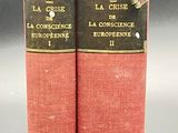 two red books sitting on top of a table next to each other