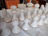 a lot of white vases on a table
