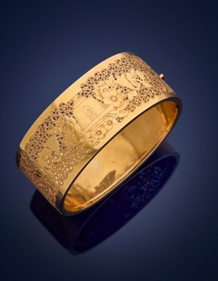 a close up of a gold ring on a blue background