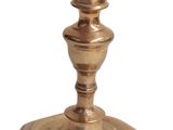 a small metal candle holder on a white background