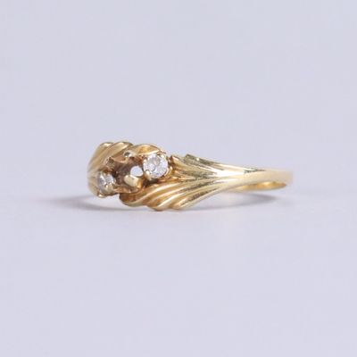an image of a gold ring with two diamonds