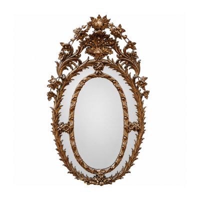 an oval mirror with a gold frame and leaves on it
