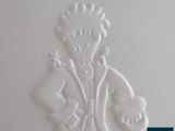 an image of a carving of a man holding a teddy bear
