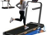 the woman is running on the treadmill with a laptop on the table