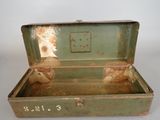 an old green suitcase with some rust on it