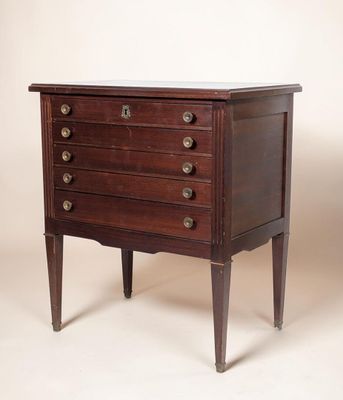 an antique chest of drawers with a marble top and wooden legs
