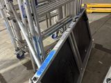 a large television sitting on top of a cart in the middle of a building