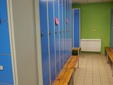 a long row of blue lockers in a hallway