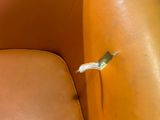 a small bird that is sitting on the arm of a chair