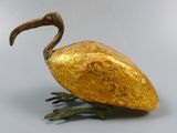 a golden bird that is sitting on a table