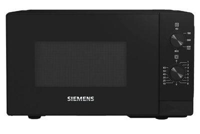 un four à micro-ondes noir posé sur un comptoir blanc