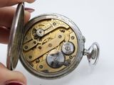 a close up of a person holding a pocket watch