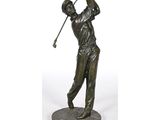 statue of a man swinging a golf club on a marble base