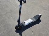 a scooter that is sitting in the parking lot
