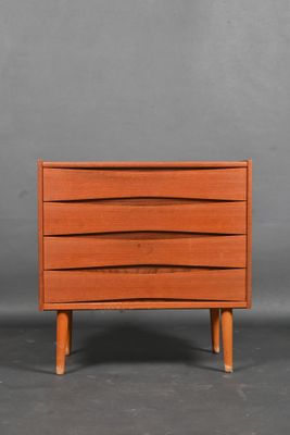 an orange chest of drawers with three drawers on each side