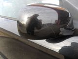 a reflection of a man in a mirror on the side mirror of a car