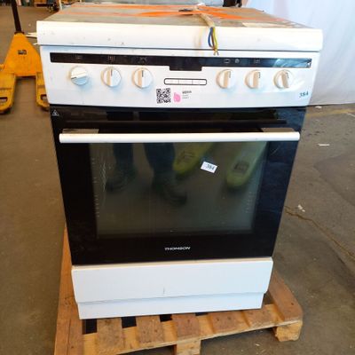 a stove that is sitting on a pallet in a warehouse