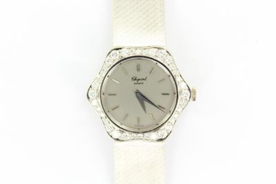an image of a close up of a wrist watch on a white surface
