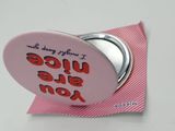 a pink button with a message on it on a pink piece of paper