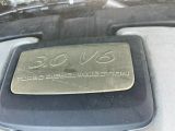 a close up of the engine of a car with a tag on it