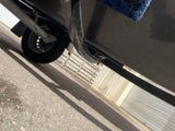 a close up of a car with a blue towel on the side of it