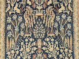 a blue and yellow rug with a floral design on it