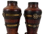 pair of decorative wooden vases with gold accents on a white background