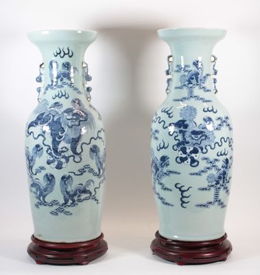two blue and white vases sitting next to each other