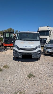 three vehicles parked in a lot next to each other