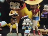many figurines of cartoon characters displayed on a table