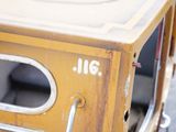 a close up of a small yellow vehicle with the door open