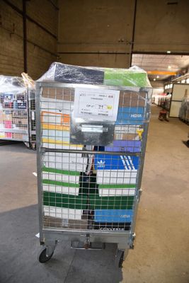 a cart with a lot of boxes on it in a warehouse