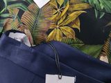 the pants are blue and green with a tropical print on them