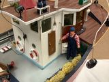a model of a boat with a man on it