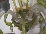 a close up of a glass vase with a plant inside of it