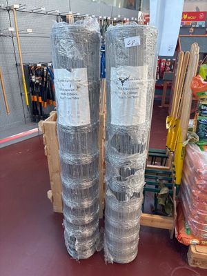 two rolls of plastic wrap on the floor in a store