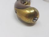 a gold and brown object on a white surface