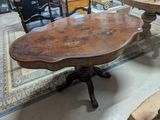 a table with a wooden top on a rug in a room