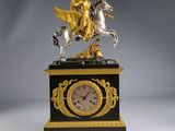 une horloge sur laquelle figure la statue d'une femme à cheval