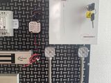 a picture of a wall mounted electrical panel with wires and switches