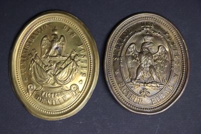 two gold coins with the image of a woman and a man on them