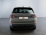 the rear end of a grey car in a white room