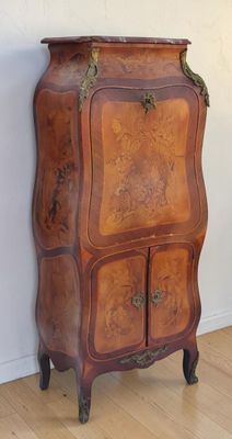 a wooden cabinet with two doors on the top of it