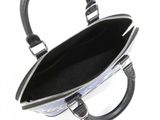 a black and white purse that is open on a white surface