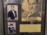 an image of a framed photograph of a man in a suit and tie