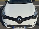 the front of a white car parked on the side of the road
