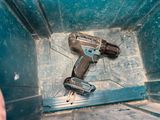 a drill and a hammer in a blue container