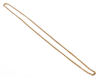 a close up of a gold necklace with a chain on a white background