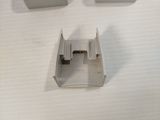 three pieces of metal are placed on a white surface