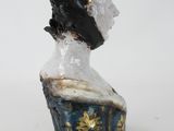 statue of a woman wearing a black hat and a blue dress